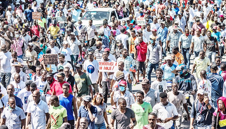 Demonstrators march in Port-au-Prince on Sunday, to protest against the government of president Jovenel Moise. Several thousand people demonstrated in the Haitian capital Port-au-Prince, saying the government was trying to establish a new dictatorship and denouncing international support for President Jovenel Moise. — AFP photo