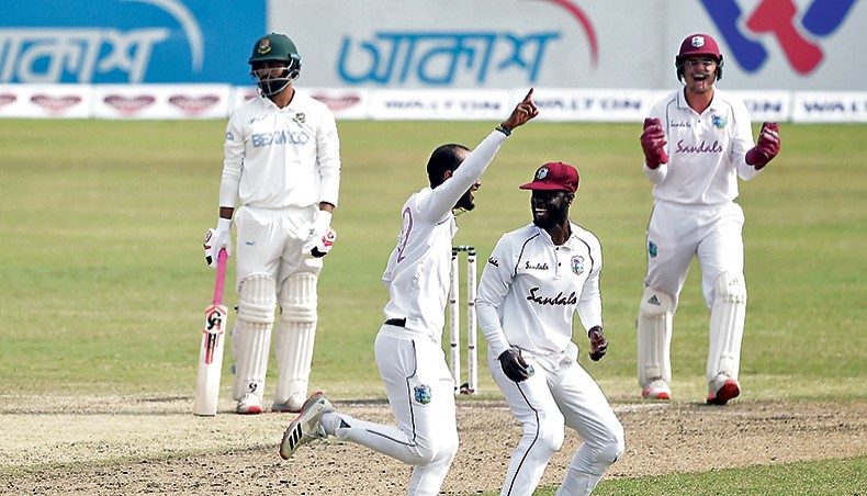 West Indies captain Kraigg Brathwaite (2nd-L) celebrates the wicket of Bangladesh batsman Tamim Iqbal (L) on the fourth day of their second Test at the Sher-e-Bangla National Stadium on Sunday. — AFP photo