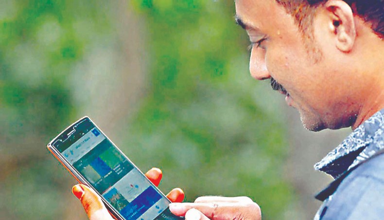 A file photo shows a man using internet on his mobile phone in Dhaka. The number of mobile phone connections of four mobile phone operators increased to 17.02 crore at the end of January with three operators gaining while leading operator Grameenphone losing connections in the month.— New Age photo