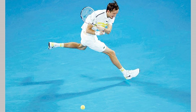 Russia’s Daniil Medvedev hits a return against Greece’s Stefanos Tsitsipas during their men’s singles semi-final match of the Australian Open in Melbourne on Friday. — AFP Photo