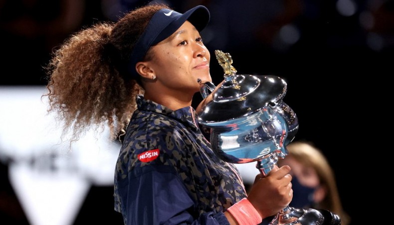 Japan's Naomi Osaka celebrates with the trophy after defeating Jennifer Brady of the US in the Australian Open women’s singles final in Melbourne on Saturday. — AFP photo