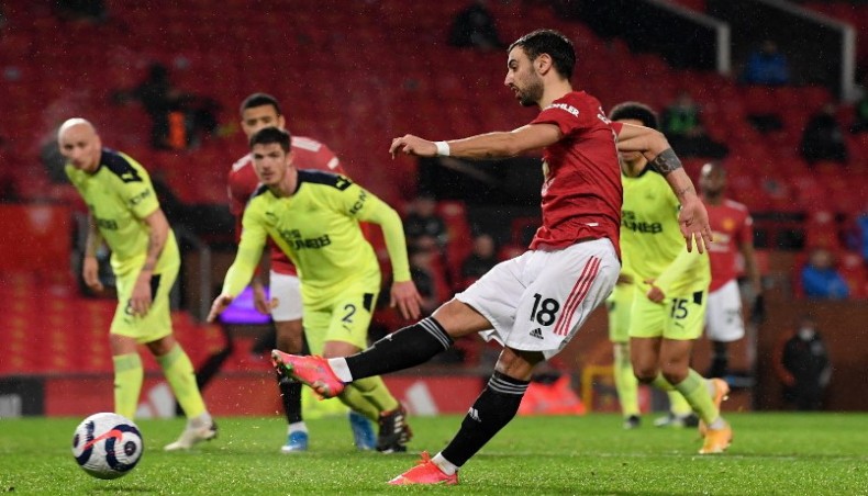 Manchester United midfielder Bruno Fernandes scores his team’s third goal from the penalty spot during their Premier League match against Newcastle United at Old Trafford on Sunday. — AFP photo