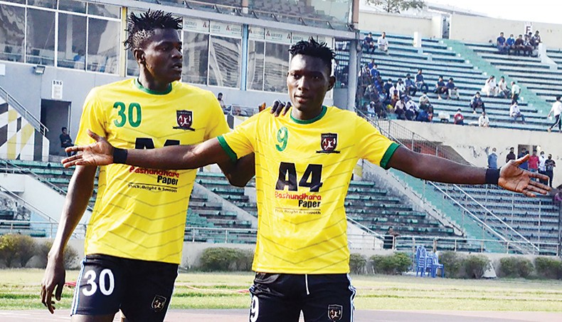 Sheikh Jamal’s Gambian forward Pa Omar Jobe (R) celebrates after scoring his team’s opening goal against Police Football Club during their Bangladesh Premier League match at the BNS on Monday. — BFF photo