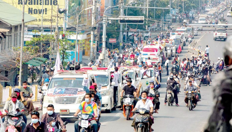 A convoy of cars makes its way during the funeral for protester Thet Naing Win, who died from a gunshot wound while taking part in a demonstration against the military coup last week, in Mandalay on Tuesday. — AFP photo
