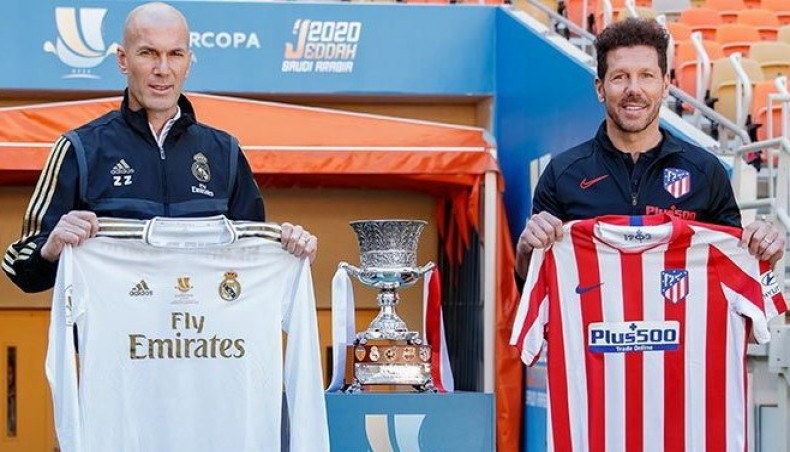 A file photo shows Real Madrid manager Zinedine Zidane and his Atletico Madrid counterpart Diego Simeone holding jersey's of their respective club's.-- Twitter photo