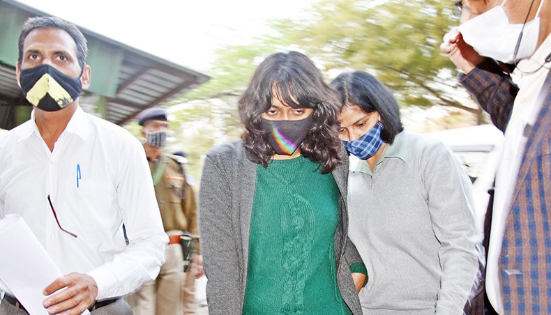Environment activist Disha Ravi, centre, is escorted after being granted bail, outside Tihar jail in New Delhi on Tuesday following her arrest for allegedly creating a ‘toolkit’ for the farmer protests that was tweeted by Greta Thunberg. — AFP photo