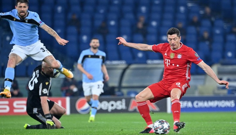 Bayern Munich forward Robert Lewandowski (R) scores his team’s opening goal against Lazio during their UEFA Champions League round of 16 first leg match at the Olympic stadium in Rome on Tuesday. — AFP photo