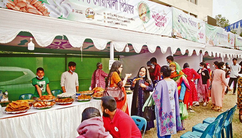 Visitors throng Bangladesh Shilpakala Academy premises on the opening day of 14th Jatiya Pitha Utsab on Tuesday. — Sony Ramany