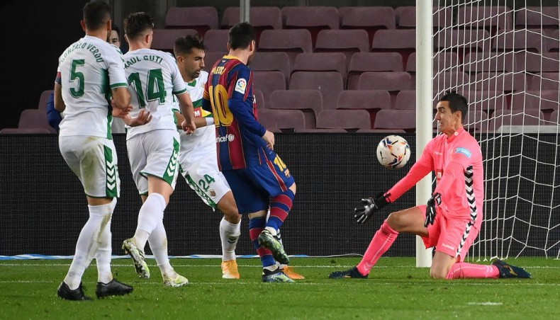 Barcelona forward Lionel Messi (C) scores his team’s second goal against Elche during their La Liga match at the Camp Nou on Wednesday.— AFP photo