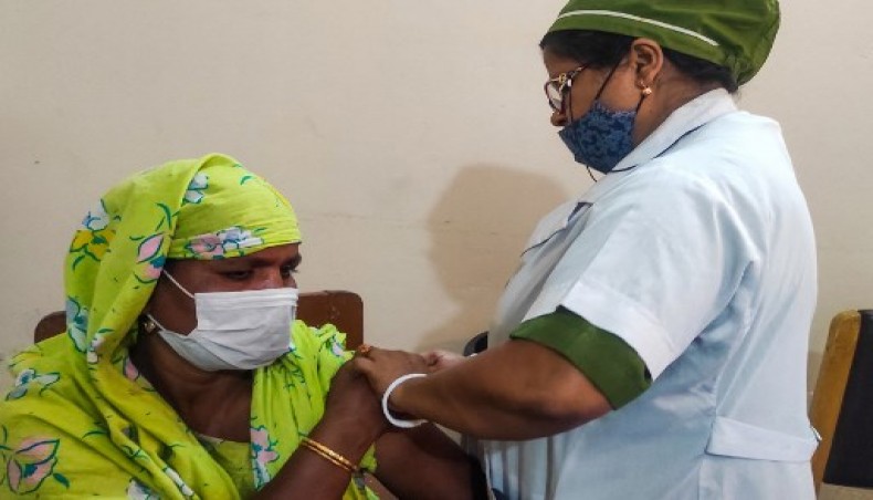 A sex worker (L) from the country's largest brothel receives a dose of a Covid-19 vaccine in Daulatdia on February 25, 2021.-AFP photo