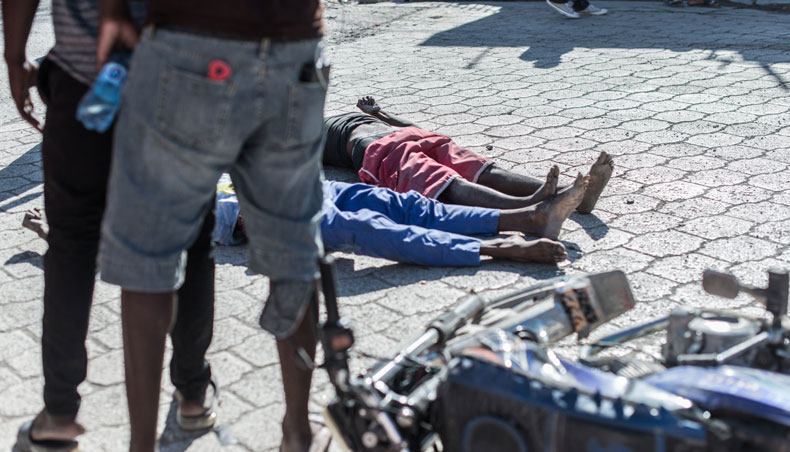 The bodies of two dead inmates lie on the pavement by the Croix-des-Bouquets prison from where many prisoners escaped and where several people were killed, in Croix-des-Bouquets, suburb of the Haitian capital, on February 25, 2021. — AFP photo