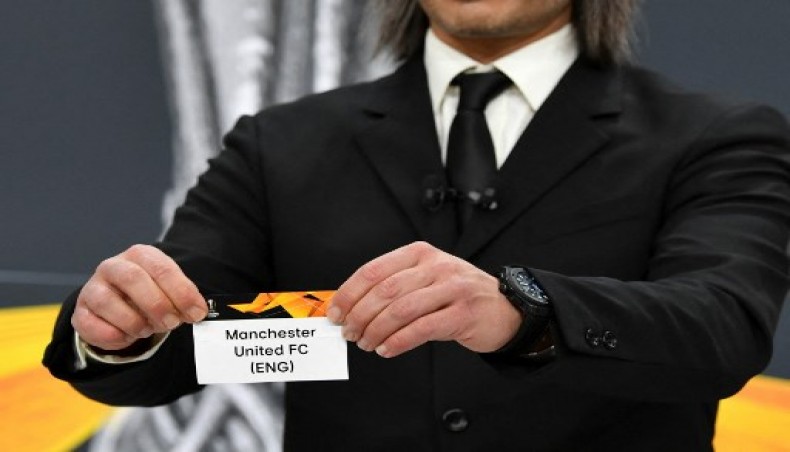 This handout picture provided by the Union of European Football Associations (UEFA) on February 26, 2021, shows Swiss former football player Hakan Yakin showing the slip of Manchester United FC during the draw for the round of 16 of the UEFA Europa League football tournament at the UEFA headquarters in Nyon.- AFP photo