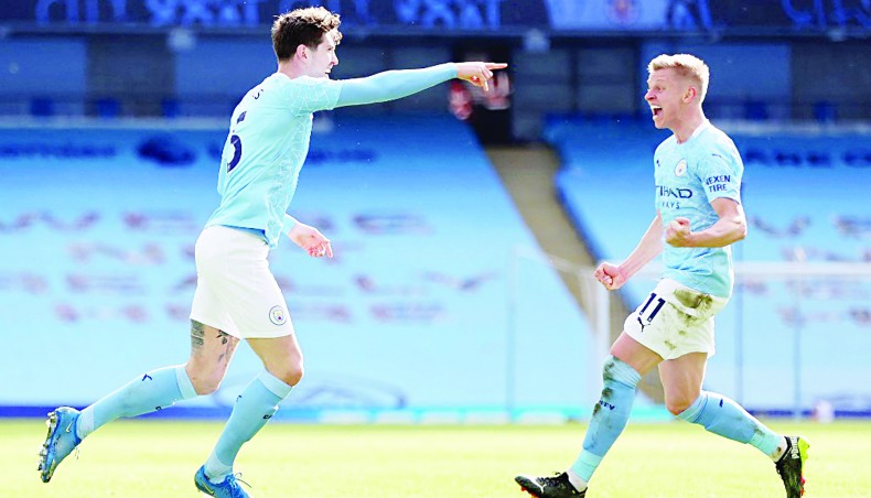 Manchester City defender John Stones (L) celebrates after scoring his team’s second goal against West Ham United during their Premier League match at the Etihad Stadium on Saturday. — AFP photo
