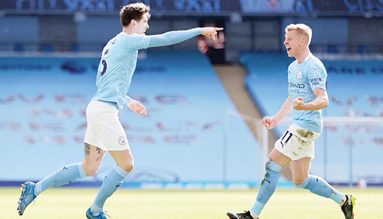 Manchester City defender John Stones (L) celebrates after scoring his team’s second goal against West Ham United during their Premier League match at the Etihad Stadium on Saturday. — AFP photo