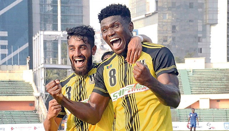 Saif Sporting Club’s Nigerian midfielder John Okoli (R) celebrates after scoring one of his two goals against Police Football Club during their Bangladesh Premier League match at the BNS on Monday. — BFF photo