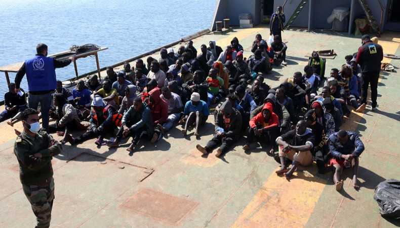 Rescued migrants sit aboard a Libyan coastguard vessel arriving at the capital Tripoli's naval base on February 28, 2021. -- AFP photo