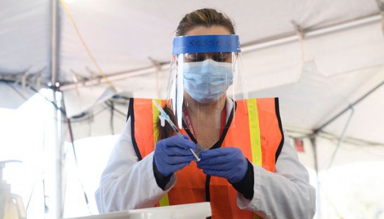A nurse prepares to administer a dose at a vaccination site for education workers including teachers and support staff in a parking lot at Hollywood Park adjacent to SoFi stadium during the COVID-19 pandemic on March 1, 2021 in Inglewood, California. — AFP photo