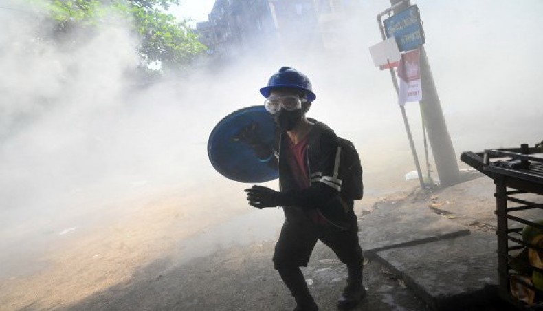A protester holds a homemade shield while running during a demonstration against the military coup in Yangon on March 3, 2021..- AFP photo