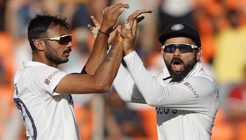 A file photo from February 25, 2021 shows India spinner Axar Patel celebrating a wicket with captain Virat Kohli on the second day of their day-night Test against England in Ahmedabad. — BCCI photo