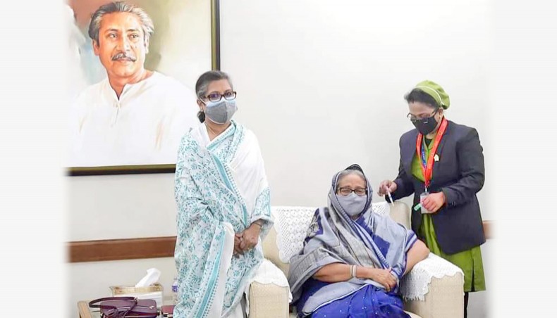 A handout photo released by Prime Minister's Office shows prime minister Sheikh Hasina receiving the first dose of COVID-19 vaccine on Thursday.- Handout photo