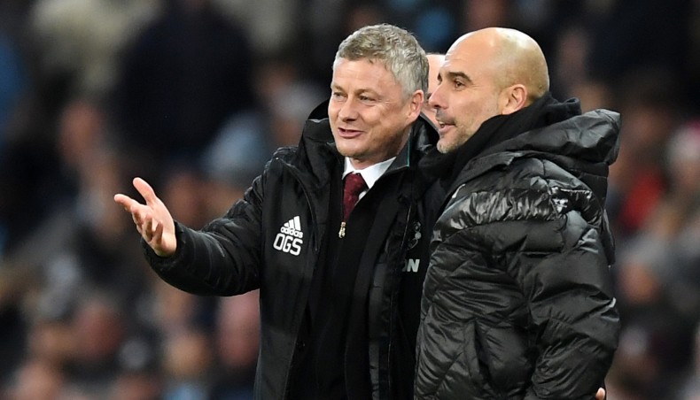 A file photo shows Manchester United manager Ole Gunner Solskjaer (L) sharing a light moment with his Manchester City counterpart Pep Guardiola. -- AFP photo