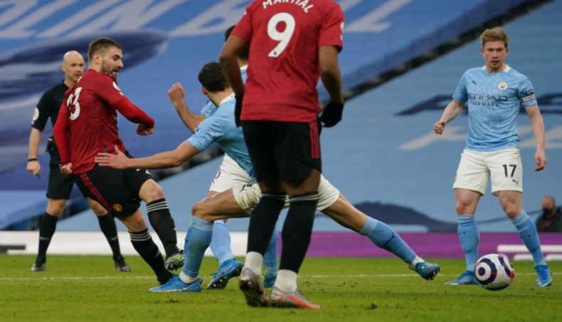 Manchester United defender Luke Shaw (L) shoots to score his team’s second goal during their Premier League match against Manchester City at the Etihad Stadium in Manchester on Sunday. — AFP photo
