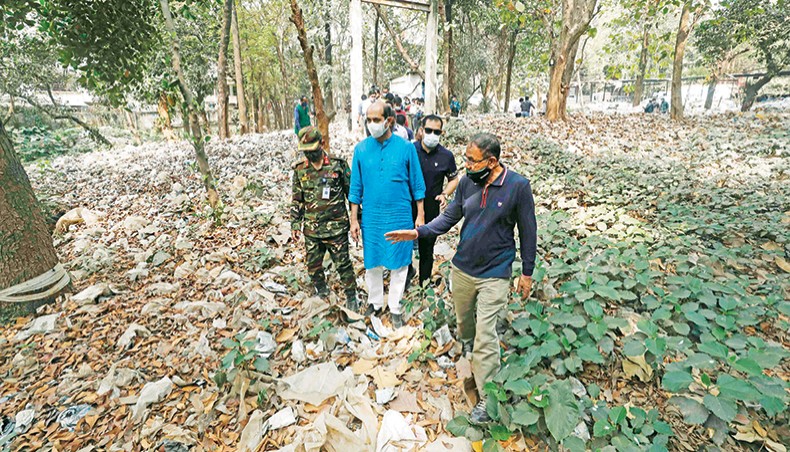 North Dhaka mayor Atiqul Islam stands next to a garbage-filled spot while on a visit to a plant area of Bangladesh Milk Producers Co-operative Union Limited at Mirpur on Monday as part of an anti-mosquito crash programme. — DNCC photo