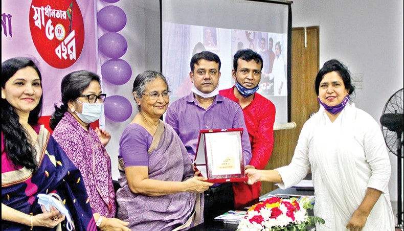 A woman journalist receives a crest as Dhaka Reporters Unity honours six senior women journalists for their contribution to journalism at its office on Tuesday marking International Women’s Day. — New Age photo