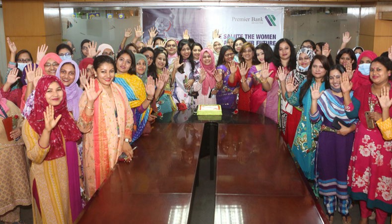 The Premier Bank officials and employees cut a cake marking International Women’s Day at its office in Dhaka on Monday. — Press release