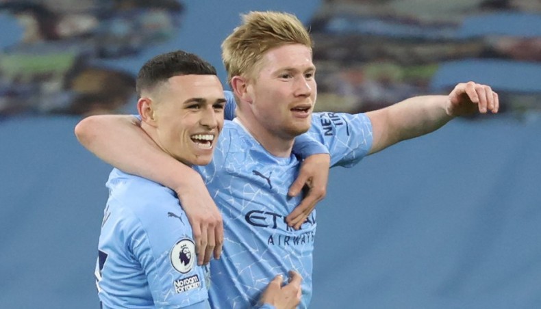 Manchester City midfielder Kevin De Bruyne (R) celebrates with team-mate Phil Foden after scoring his team’s fifth goal during their Premier League match against Southampton at the Etihad Stadium on Wednesday. — AFP photo