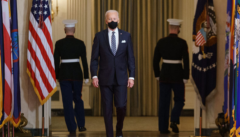 US president Joe Biden walks from the State Dining Room to the East Room to deliver an address to the nation on the anniversary of the start of the COVID-19 pandemic, in the East Room of the White House in Washington, DC on March 11, 2021. — AFP photo
