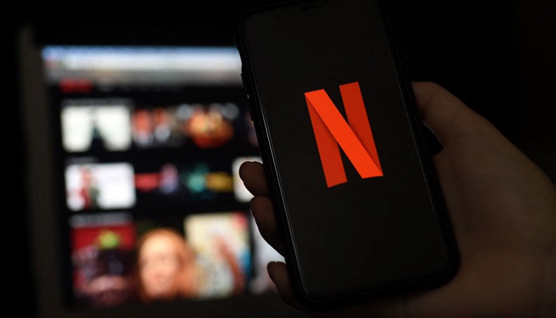 In this file photo illustration a computer and a mobile phone screens display the Netflix logo on March 31, 2020 in Arlington, Virginia. — AFP Photo