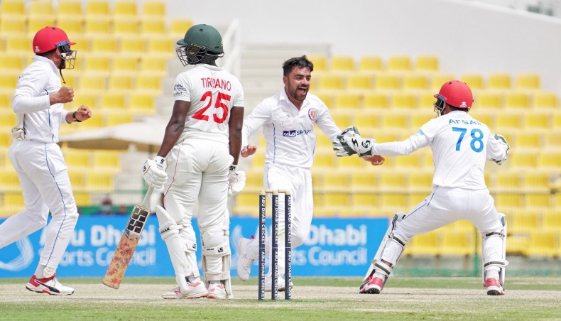 Afghanistan spinner Rashid Khan (C) celebrates the wicket of Zimbabwe batsman Donald Tiripano on the fifth day of their second Test in Abu Dhabi on Sunday. — Abu Dhabi Cricket photo