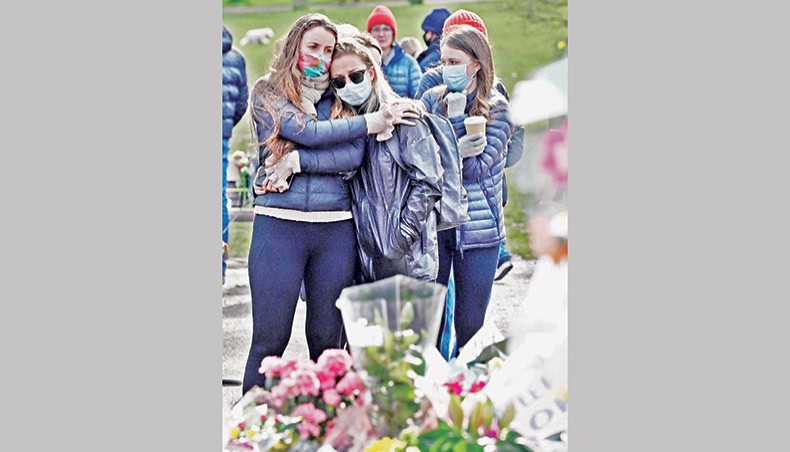 Well-wishers gather beside floral tributes to honour alleged murder victim Sarah Everard at the bandstand on Clapham Common in south London on Sunday, a day after Metropolitan Police officers scuffled at the spot with some members of a hundreds-strong crowd that gathered for a candlelit tribute. — AFP photo