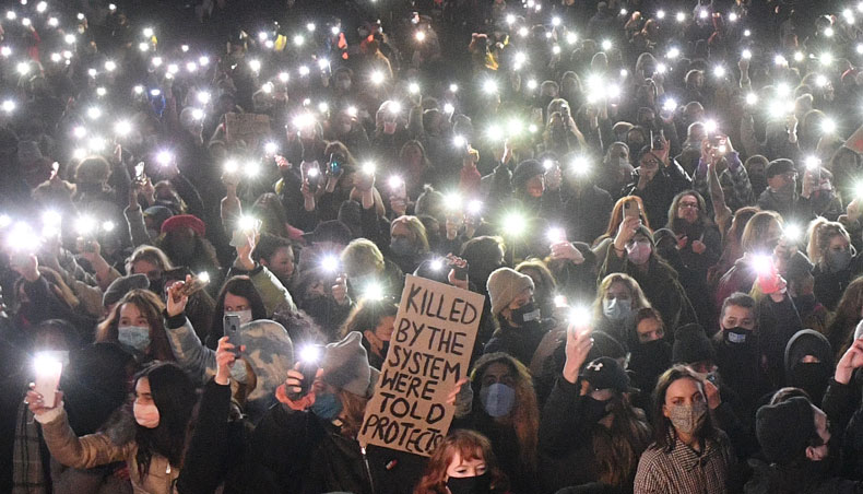 Well-wishers turn on their phone torches as they gather at a band-stand where a planned vigil in honour of alleged murder victim Sarah Everard was cancelled after police outlawed it due to COVID-19 restrictions, on Clapham Common, south London on March 13, 2021. — AFP photo