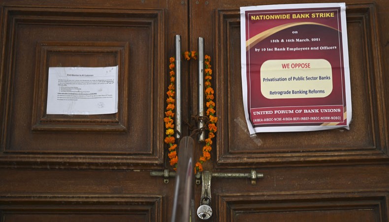 The entrance door of a closed bank is pictured during a two-day nationwide bank strike in New Delhi on March 15, 2021. — AFP photo