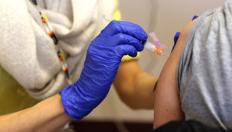 Kim Vo, a pharmacist from the Seattle Indian Health Board, administers the first of two COVID-19 Moderna vaccine shots to staff from the Seattle Public Schools on March 15, 2021 in Seattle, Washington. — AFP photo