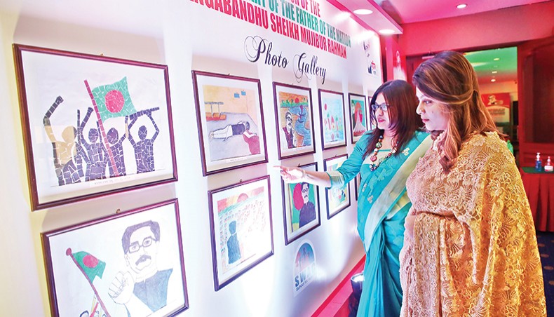Visitors look at paintings by children with autism at a programme held at Pan Pacific Sonargaon Dhaka on Tuesday. — Sony Ramany