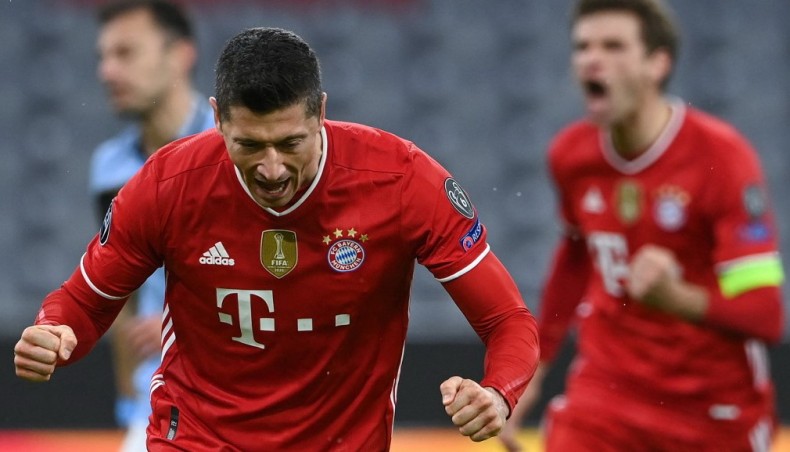 Bayern Munich forward Robert Lewandowski (L) celebrates after scoring his team’s opening goal against Lazio during their UEFA Champions League last-16, second leg, match at the Allianz Arena in Munich on Wednesday. — AFP photo