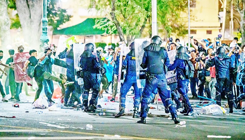 Riot police clash with pro-democracy protesters at an anti-government demonstration in Bangkok on Saturday. — AFP photo