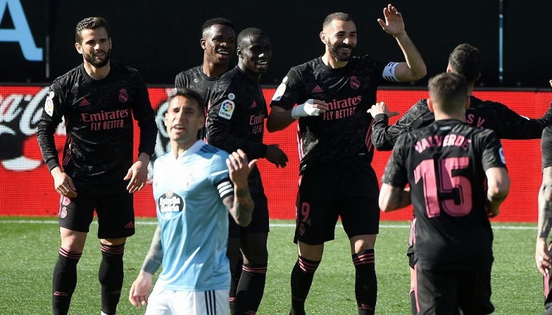 Real Madrid forward Karim Benzema (3rd-R) celebrates with team-mates after scoring against Celta Vigo during their La Liga match at the Balaidos stadium in Vigo on Saturday. — AFP photo