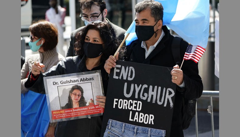 Protestors hold signs as they gather during a rally for Uyghur freedom in New York on March 22, 2021. — AFP Photo