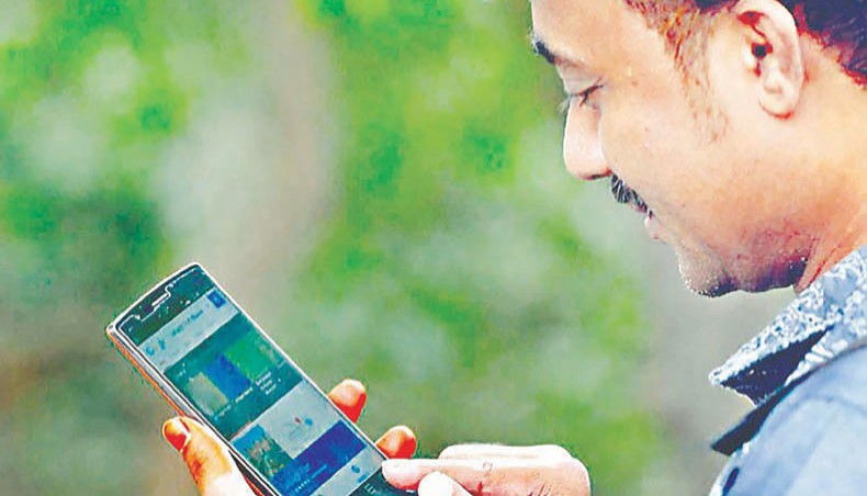 A file photo shows a man using internet on his mobile phone in Dhaka. The country’s mobile phone operators have failed to comply with the regulatory requirement in providing 4G data download speed to their subscribers with state-owned Teletalk identified as the poorest operator.— New Age photo