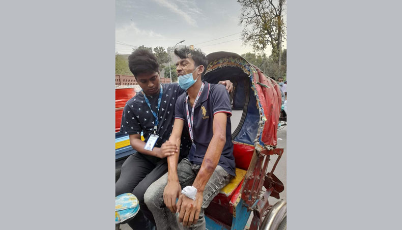 Injured journalist Abid Hasan Rasel is being taken to hospital.- New Age photo