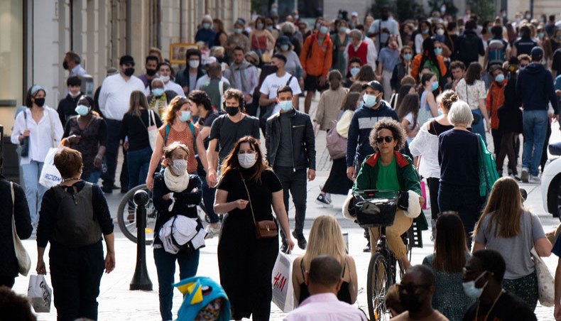 Hundreds of people walk down a street of Nantes, western France on April 1, 2021, a day after French president announced new COVID-19 restrictions. — AFP photo
