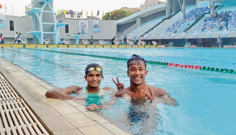 Bangladesh Navy swimmers Asif Reza and his wife Sonia Akter Tumpa (L) pose for a photograph after winning gold medals in the men’s and women’s 50metre freestyle events of the 9th Bangladesh Games at the Syed Nazrul Islam National Swimming Complex in Mirpur on Sunday. — Courtesy photo