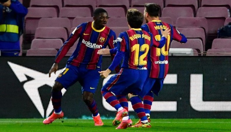 Barcelona forward Ousmane Dembele (L) celebrates with team-mates after scoring his team's winning goal against Real Valladolid during their La Liga match at the Camp Nou on Monday.-- AFP photo