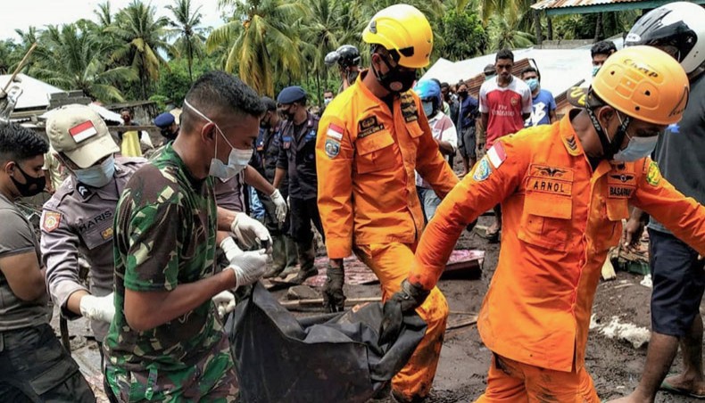 This handout photo taken on April 7, 2021 and released by the National Search and Rescue Agency shows rescuers carrying mud-covered bodies from the debris in the village of Waimatan in Lembata in East Flores, after flooding in Indonesia and East Timor left scores dead. — AFP Photo