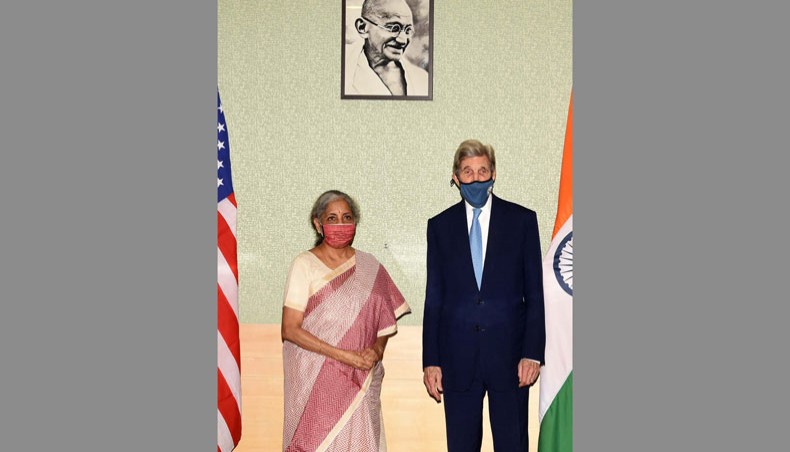 In this handout photograph taken on April 6, 2021 and released by the Indian Press Information Bureau Union minister for finance and corporate affairs Nirmala Sitharaman and US special presidential envoy for climate John Kerry, right, pose for a picture during their meeting in New Delhi. — AFP Photo