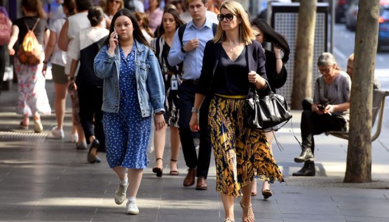 People walk through Melbourne's central business district on April 8, 2021 after the Australian government announced Australian politicians will no longer be exempt from rules against sexual harassment at work, the conservative government as it tries to quell public anger over parliamentary sex abuse scandals. -- AFP photo